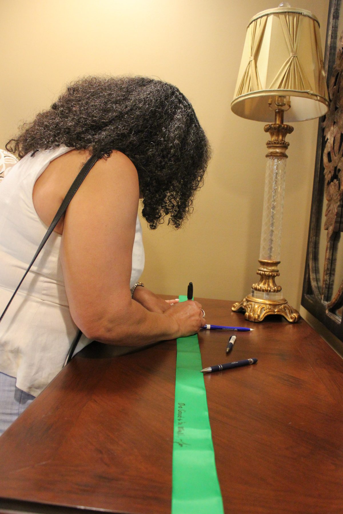 Signing the ribbon at the chamber ceremony